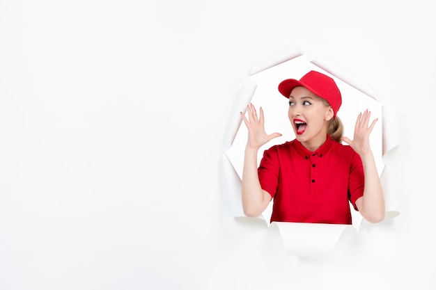 Excited female worker in red uniform on white