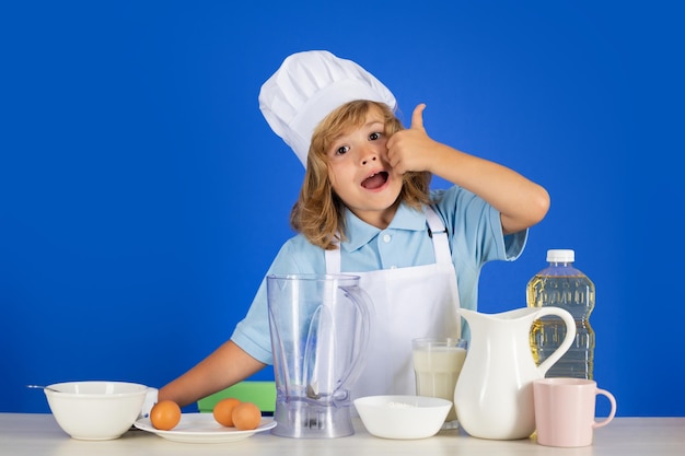 Excited funny chef cook child chef isolated on blue funny little kid chef cook wearing uniform cook