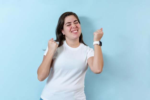 Excited girl on light blue background