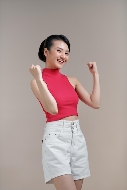 Excited happy young Indian woman expressing shock with hands gestures