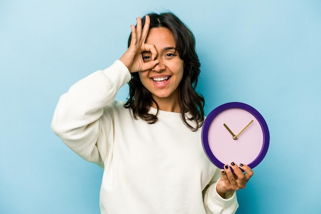 Excited keeping ok gesture on eye