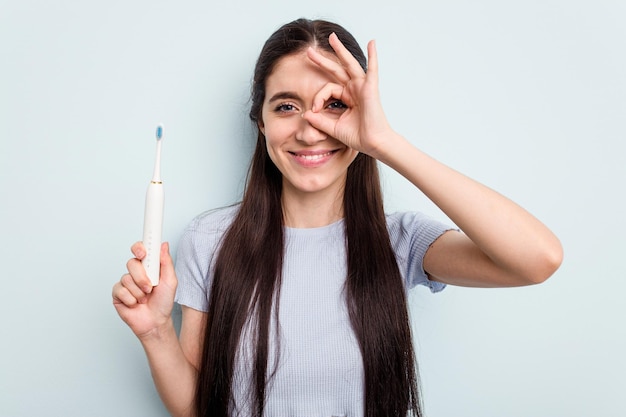 Excited keeping ok gesture on eye