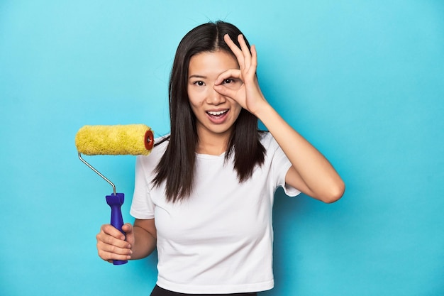 Excited keeping ok gesture on eye