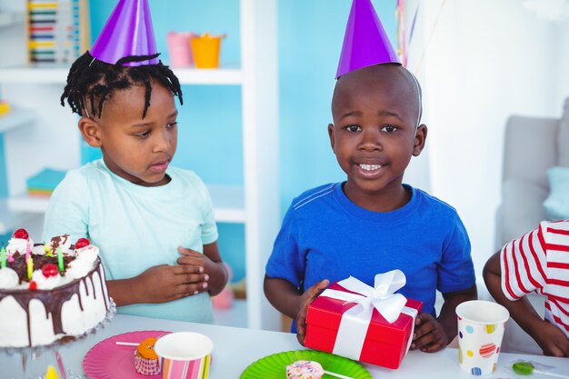 Excited kid enjoying a birthday party looking at the camera