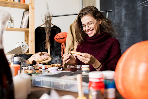 Photo excited lady making halloween cookie more realistic