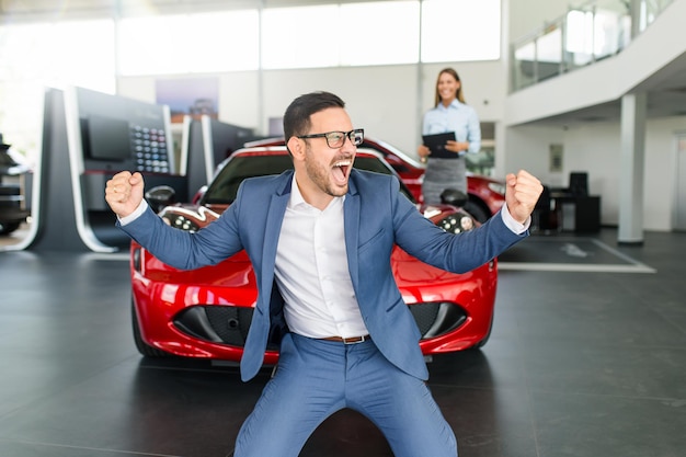 Excited man happy because of buying a new car.