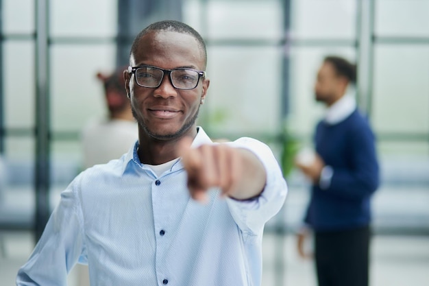 Excited young african man pointing at camera