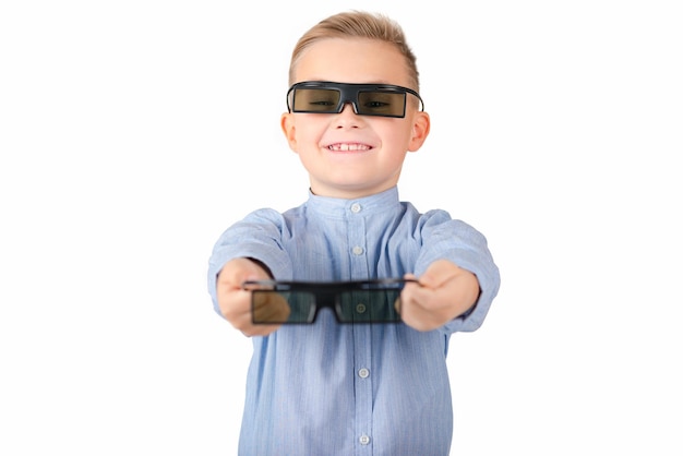 Excited young american schoolboy in 3d imax glasses posing on white isolated background in studio People lifestyle concept Mock up copy space