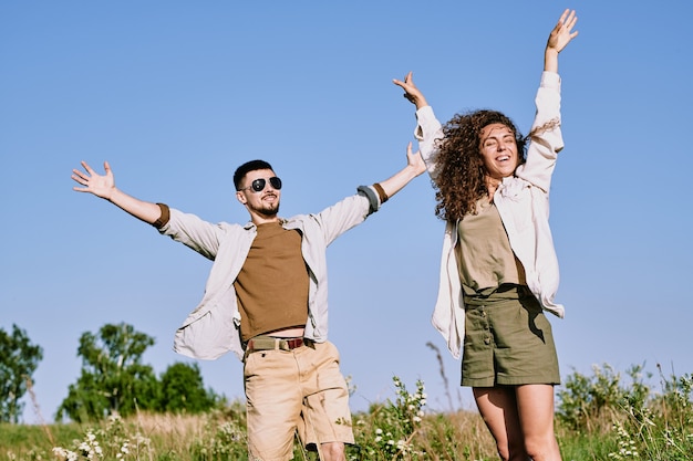 Excited young couple in country