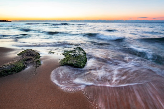 Exciting long exposure sunrise over the sea