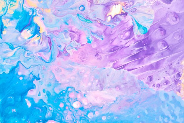 Exclusive beautiful pattern abstract fluid art background Flow of blending purple lilac blue paints mixing together Blots and streaks of ink texture for print and design