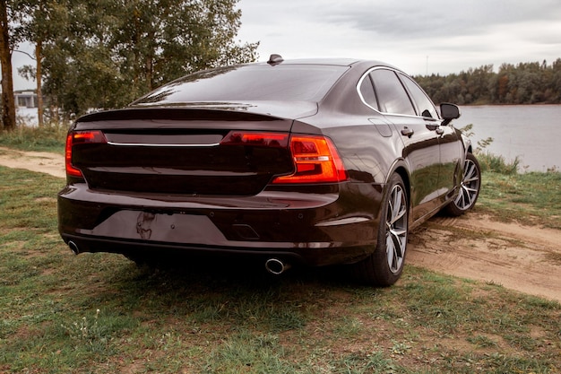 Executive sedan parked by the lake