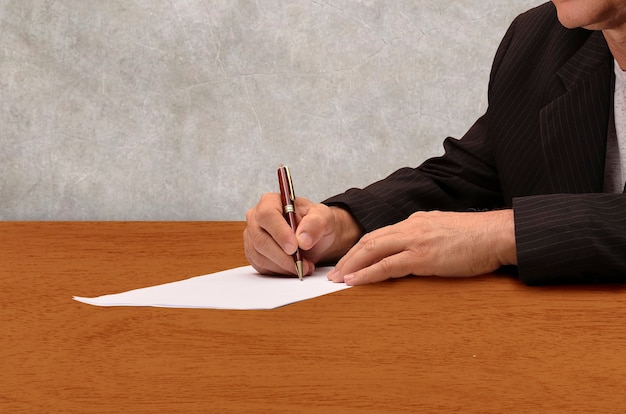 Executive signing contract on a table