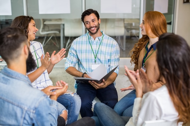 Executives appreciating their colleague during presentation