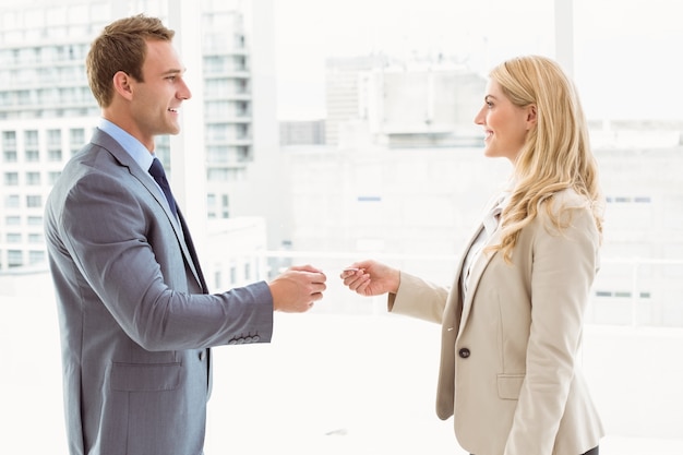 Executives exchanging business card in office