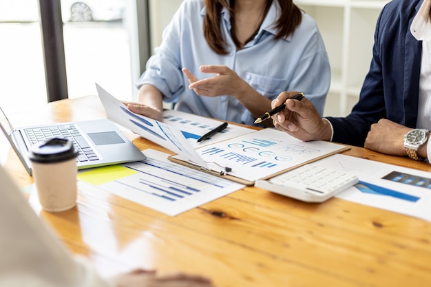 Executives and managers are meeting in a conference room, on the table there are some documents about the company's finances, managers are discussing financial information with the management.