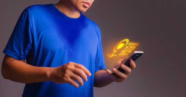 Exercise application on smart phone in hand. Concept of hologram Exercise app.