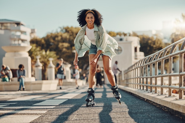 Exercise city and black woman roller skating for fitness health and wellness outdoors Sports practice training and portrait of happy female skater in street having fun and enjoying exercising