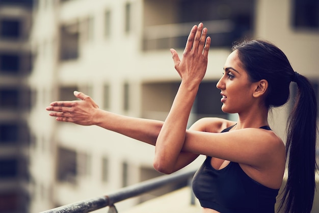 Exercising plays a vital role in our lives Shot of a beautiful young woman practising yoga outdoors