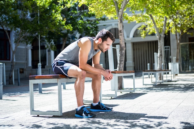 Exhausted athlete resting on a bench