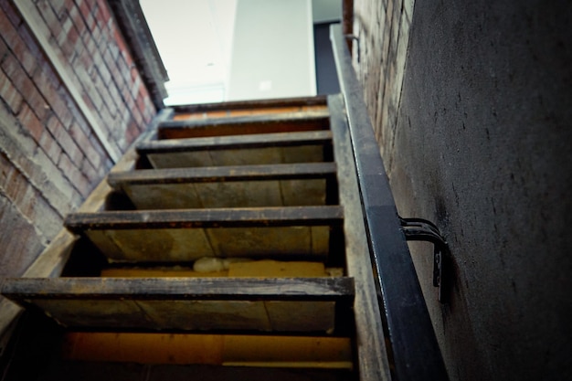 Exit from the brick cellar with a railing up the stairs to the light