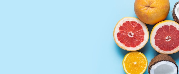 Exotic fruits on a blue background. Coconut, orange, grapefruit