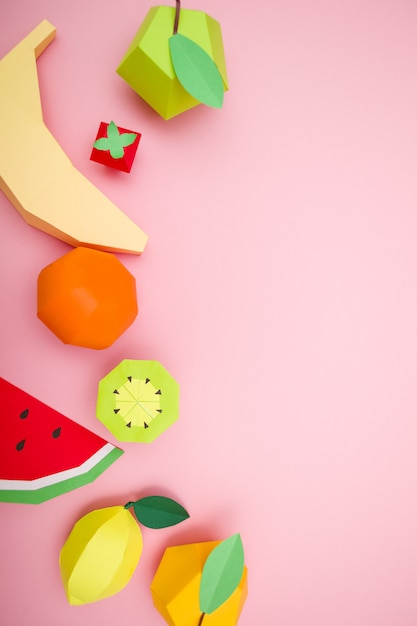 Exotic fruits made of paper on pink background