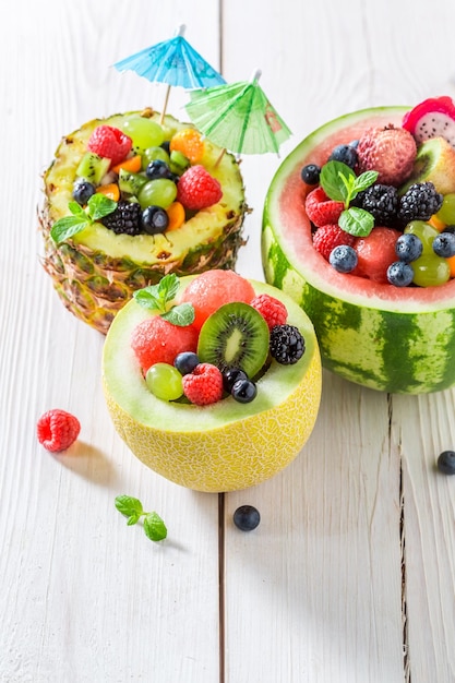 Exotic fruits salad in watermelon with berry fruits