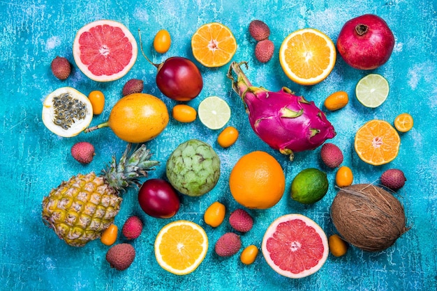 Exotic fruits on vibrant concrete slateflat lay