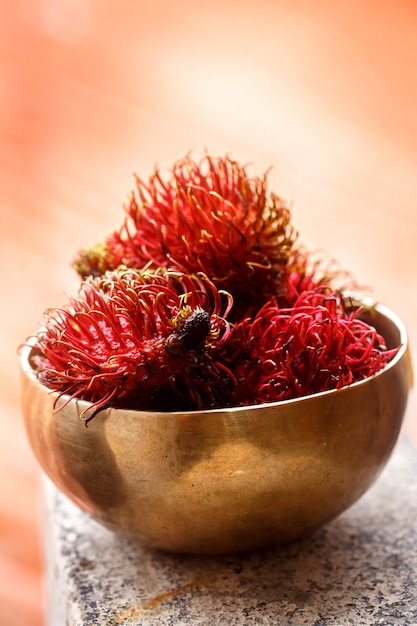 Exotic hairy fruit rambutan in rustic style