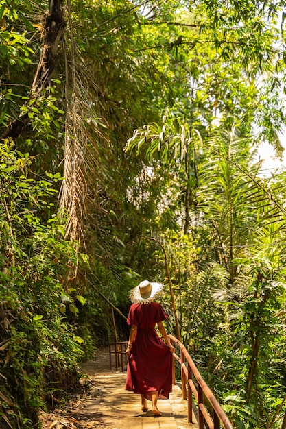 Exotic views. Pleased girl wearing hat during walk, enjoying her trip to Bali stock photo