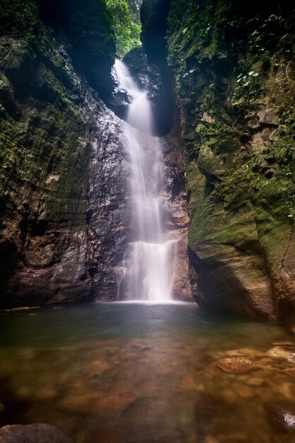 Exotic waterfalls surrounded by rocky cliffs create a natural dramatic impression