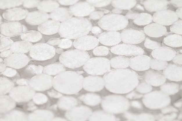 Expanded polystyrene foam porous surface small cut spheres closeup selective focus