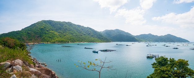 Expansive view of scenic tropical bay, lush green woodland and blue waving sea. The easternmost coast in Vietnam, Phu Yen province between Da Nang and Nha Trang.