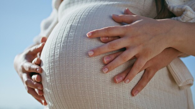 Photo expectant parents hands touching big female belly close up pregnant couple