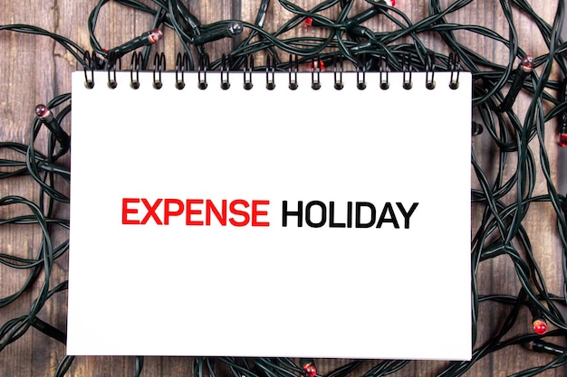 Expense holiday text concept on the background of the included light bulbs Expense during holidays counting expenses for vacations and holidays concept