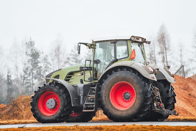 Expensive European green tractor on a rural road