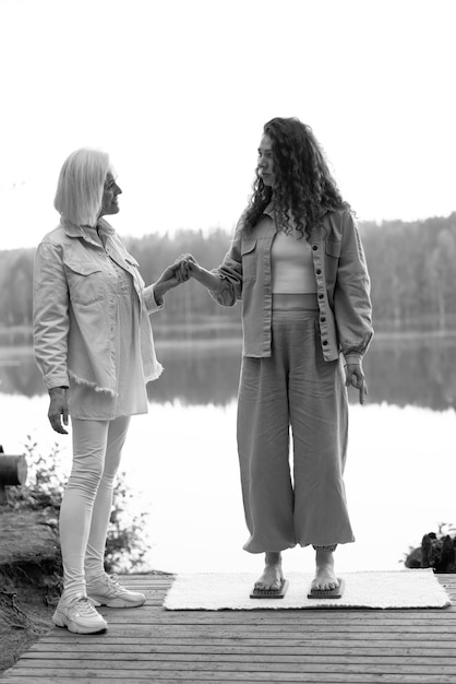 An experienced coach helps the girl stand barefoot on a board with nails.