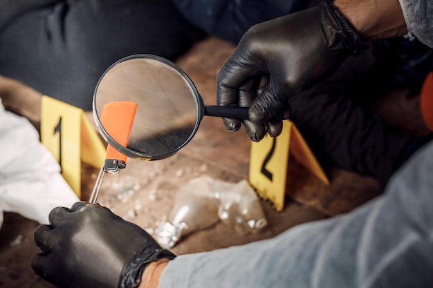 An expert is gathering evidence at a crime scene The law and the concept of police forensics