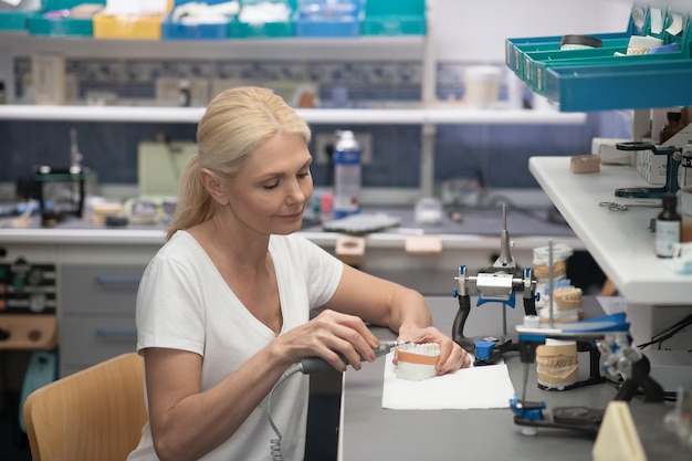 An expert working with plaster prosthesis at the dental office