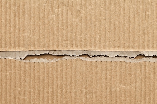 Photo exploring texture and depth the aesthetic impact of torn cardboard backgrounds