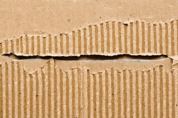 Photo exploring texture and depth the aesthetic impact of torn cardboard backgrounds