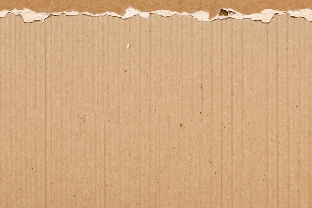 Photo exploring texture and depth the aesthetic impact of torn cardboard backgrounds