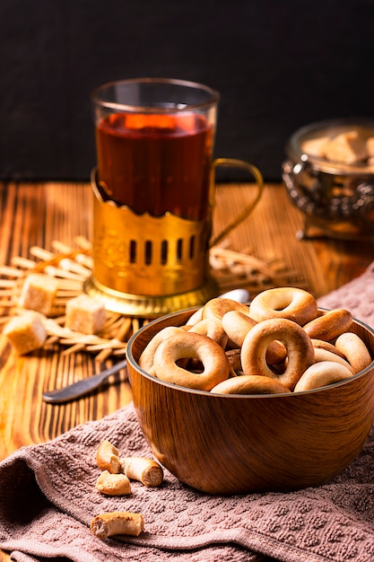 Exposition of home made bagels with tea on wooden table.