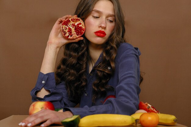 Expressive beautiful lady posing with fruits