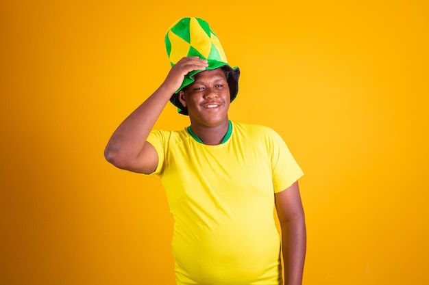 Expressive brazilian fan on yellow background