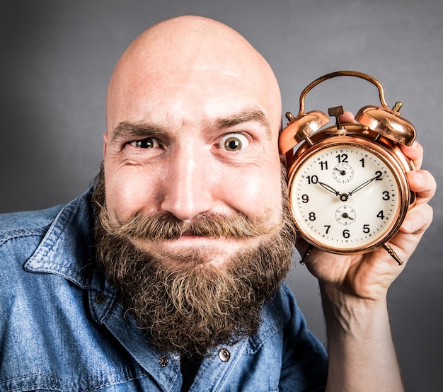 Expressive man with alarm clock