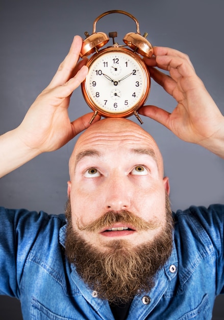 Expressive man with alarm clock