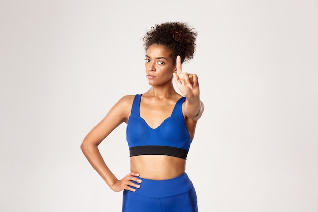 Expressive woman in fitness clothing posing