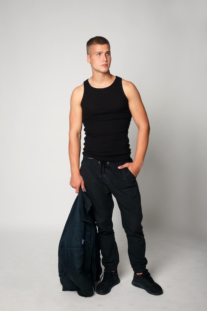 Expressive young stylish man in black tshirt